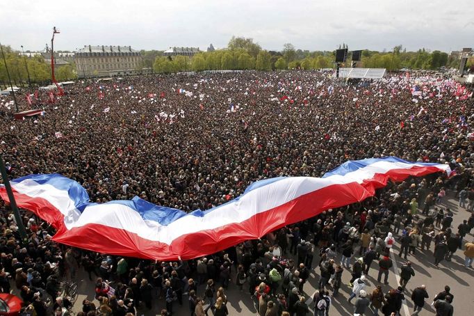 A giant banner in the colours of the French national flag is seen in this general view of tens of thousands of supporters of Francois Hollande, Socialist Party candidate, who attend a campaign rally near the Chateau de Vincennes