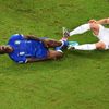 Italy's Balotelli falls after being tackled by England's Cahill during their 2014 World Cup Group D soccer match at the Amazonia arena in Manaus