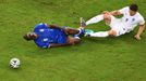 Italy's Mario Balotelli falls after being tackled by England's Gary Cahill (R) during their 2014 World Cup Group D soccer match at the Amazonia arena in Manaus June 14, 2