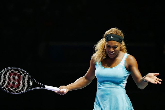 Serena Williams of the U.S. reacts after losing a point to Caroline Wozniacki of Denmark during their WTA Finals singles semi-finals tennis match at the Singapore Indoor