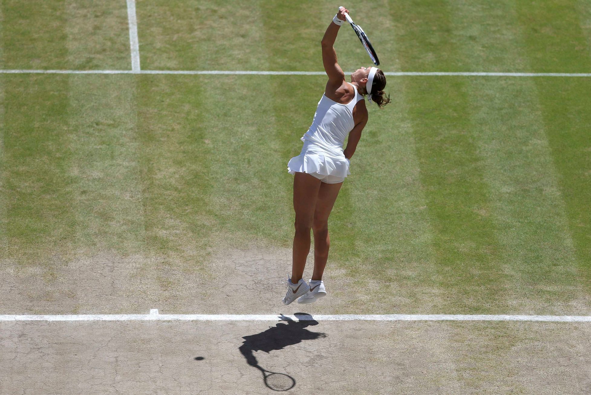 Lucie Safarova of the Czech Republic serves during her women's singles semi-final tennis match against Petra Kvitova of the Czech Republic at the Wimbledon Tennis Championships, in London