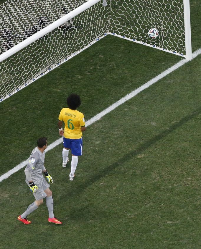 Brazil's Julio Cesar (L) watches after teammate Marcelo scored an own goal during the 2014 World Cup opening match against Croatia at the Corinthians arena in Sao Paulo J