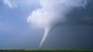 A long slender, white tornado A long slender, white tornado churns across farmland near Stuart, Nebraska. This same storm produced a large long track tornado north of O'neill that resulted in the destruction of several farmsteads.