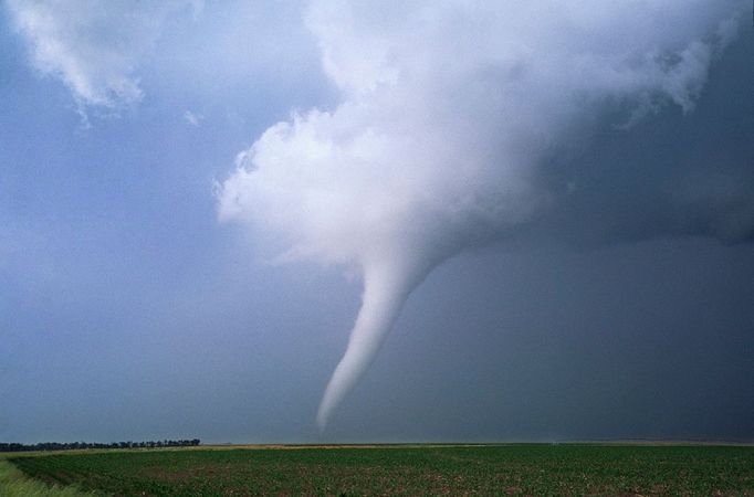 A long slender, white tornado A long slender, white tornado churns across farmland near Stuart, Nebraska. This same storm produced a large long track tornado north of O'neill that resulted in the destruction of several farmsteads.