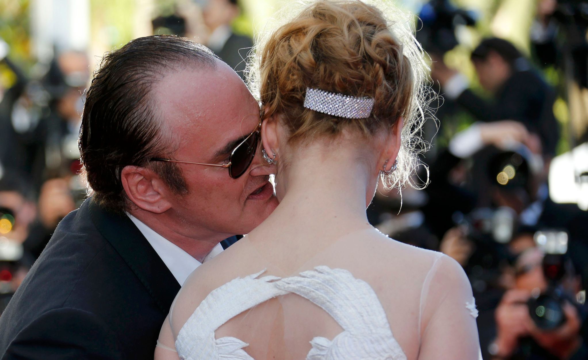 Director Quentin Tarantino and actress Uma Thurman pose on the red carpet as they arrive at the closing ceremony of the 67th Cannes Film Festival