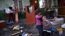 Nazareth Duval (L) combs her cousin Yasmin's hair as their aunt Rosa Gabarri cleans the furniture which she is removing from her parents' home a day before its demolition at the Spanish gypsy settlement of Puerta de Hierro outside Madrid February 14, 2012. Fifty-four families have been living in Puerta de Hierro, on the banks of the Manzanares river for over 50 years. Since the summer of 2010, the community has been subject to evictions on the grounds that the dwellings are illegal. Families whose houses have been demolished, move in with relatives whose houses still remain while the debris keeps piling up around them as more demolitions take place. Picture taken February 14, 2012. REUTERS/Susana Vera (SPAIN - Tags: SOCIETY) ATTENTION EDITORS - PICTURE 12 OF 31 FOR PACKAGE 'GYPSY SITE DEMOLISHED' SEARCH 'GYPSY SITE' FOR ALL IMAGES Published: Lis. 5, 2012, 4:11 odp.