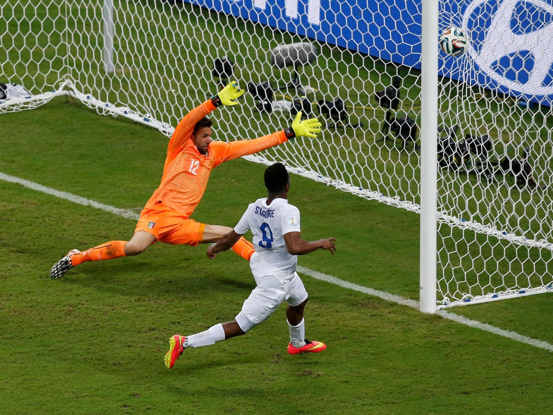 England's Sturridge scores past Italy's goalkeeper Sirigu during their 2014 World Cup Group D soccer match at the Amazonia arena in Manaus