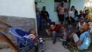 Luis Salgado (C, red shirt), nicknamed Chucho, spends time with family and friends at their home in the village of Sagua La Grande in central Cuba, March 10, 2013. Chucho was granted a U.S. visa based on his father's status as legal resident in Texas, and he was reunited in Miami with his father, Jesus Salgado, who had escaped Cuba on a frail boat ten years earlier. The Salgados are among many Cubans taking advantage of Cuba's new travel policy in place since last January, which allows citizens to leave the country with just a passport and no need for much-hated exit visas required since 1961. Picture taken March 10, 2013. REUTERS/Desmond Boylan (CUBA - Tags: POLITICS SOCIETY) Published: Dub. 11, 2013, 2:04 odp.