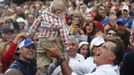 Republican presidential nominee Mitt Romney holds a baby up in the air after a campaign rally at the Golden Lamb in Lebanon, Ohio October 13, 2012. REUTERS/Shannon Stapleton (UNITED STATES - Tags: POLITICS ELECTIONS USA PRESIDENTIAL ELECTION TPX IMAGES OF THE DAY) Published: Říj. 13, 2012, 10:34 odp.