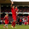 Liverpool's Luis Suarez reacts to the crowd with his children Benjamin and Delfina following their final soccer match of the Premier League season against Newcastle United which they won 2-1, at Anfie
