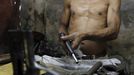 A Filipino gunsmith assembles a pistol in an illegal makeshift gun factory on the outskirts of Danao in central Philippines July 8, 2012. In the Philippines, they vote with their trigger fingers. Elections mean big business for illegal gunsmiths, who are looking forward to 2013 mid-term polls. With election-related violence commonplace, the Philippines imposes a ban on the carrying of guns for six months, from campaigning to the proclamation of winners. Picture taken July 8, 2012. To match Feature PHILIPPINES-GUNS/ REUTERS/Erik De Castro (PHILIPPINES - Tags: SOCIETY POLITICS BUSINESS CRIME LAW) Published: Čec. 29, 2012, 2:28 dop.