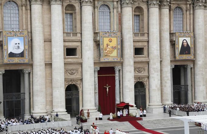 Tapestries hang on Saint Peter's Basilica during a canonization mass led by Pope Francis at the Vatican May 12, 2013. The Pope is leading a mass on Sunday for candidates for sainthood Antonio Primaldo, Mother Laura Montoya and Maria Guadalupe Garcia Zavala.