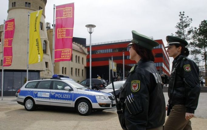 German police women patrol in front of the Hans-Otto theatre during the world premiere of a dramatised version of the novel from the book the 'Satanic Verses' by British author Salman Rushdie in Potsdam near Berlin March 30, 2008. The highly controversial novel, which was published in the late 1980s and caused outrage among Muslims who deemed it blasphemous, has been staged as a dramatic performance for the first time on Sunday under tight police control. REUTERS/Fabrizio Bensch (GERMANY)