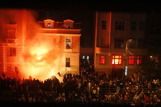 Plameny šlehají z okna americké ambasády. Rozzuření demonstranti vytrhali mříže v oknech a vtrhli dovnitř. Zaměstnanci ambasády byli včas evakuováni, srbská policie ale budovu nebránila.