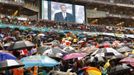 South Africans brave the rain as they listen to U.S. President Barack Obama speak