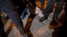 A picketer is arrested by riot police officers after trying to close a pub with other picketers at the start of a nationwide general strike in Malaga, southern Spain early November 14, 2012. Spanish and Portuguese workers will stage the first coordinated general strike across the Iberian Peninsula on Wednesday, shutting transport, grounding flights and closing schools to protest against spending cuts and tax hikes. REUTERS/Jon Nazca (SPAIN - Tags: BUSINESS EMPLOYMENT CIVIL UNREST POLITICS) Published: Lis. 14, 2012, 7:21 dop.