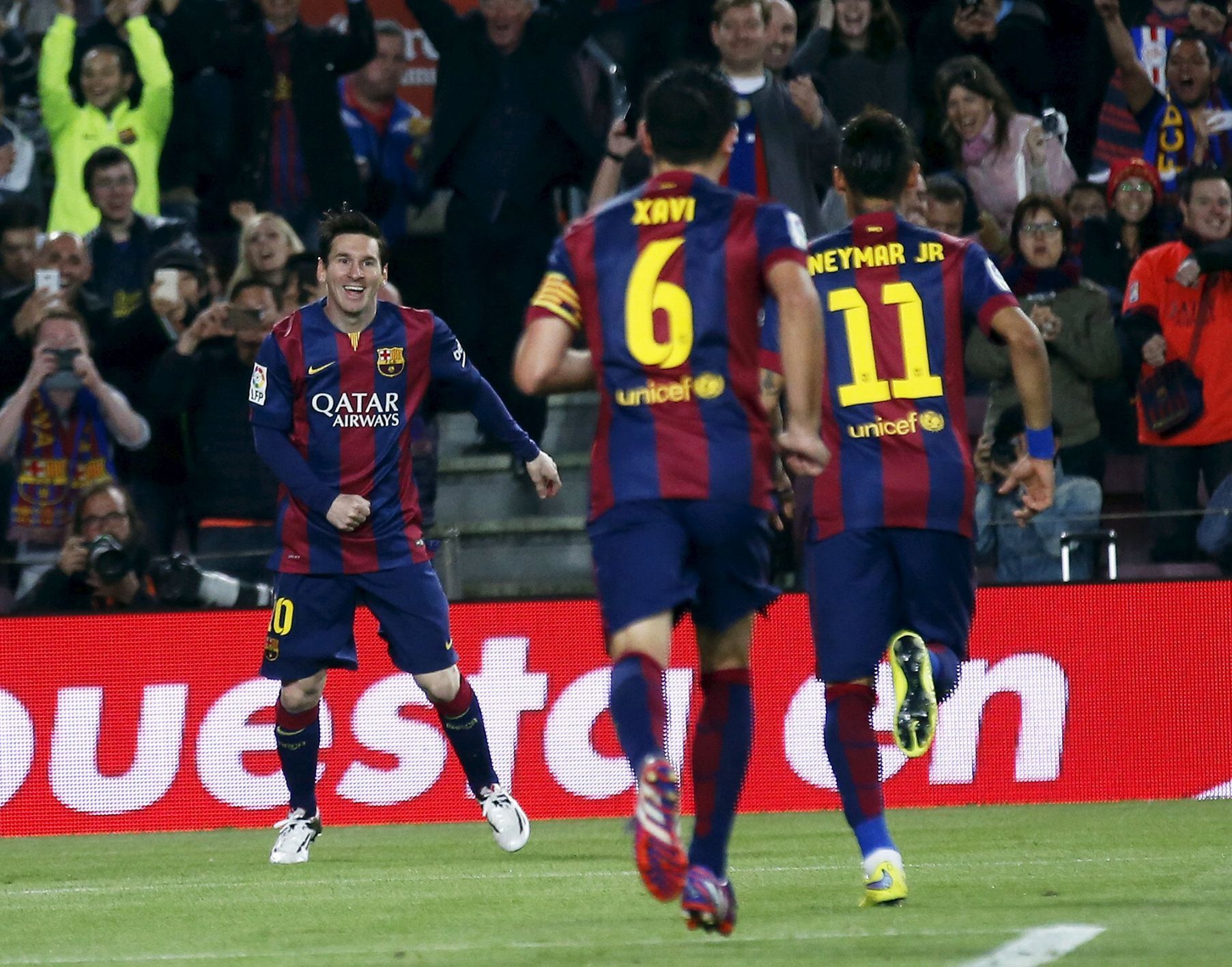 Barcelona's Lionel Messi celebrates his second goal with teammates Xavi Hernandez and Neymar against Getafe during their Spanish first division soccer match at Nou Camp stadium in Barcelona