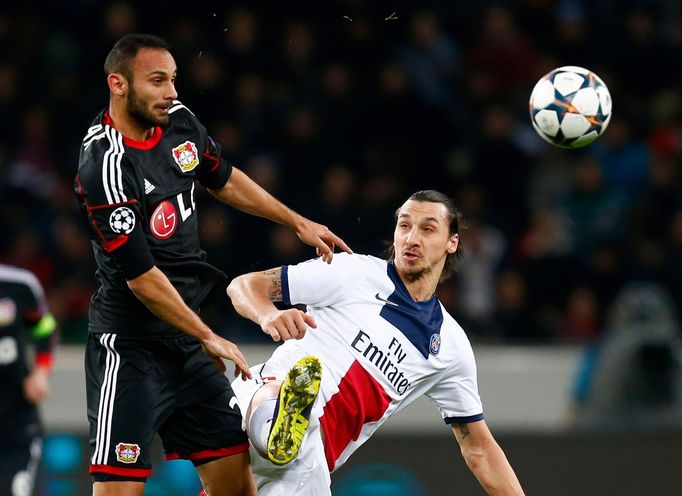 Bayer Leverkusen's Toprak challenges Paris St Germain's Ibrahimovic during their Champions League soccer match in Leverkusen