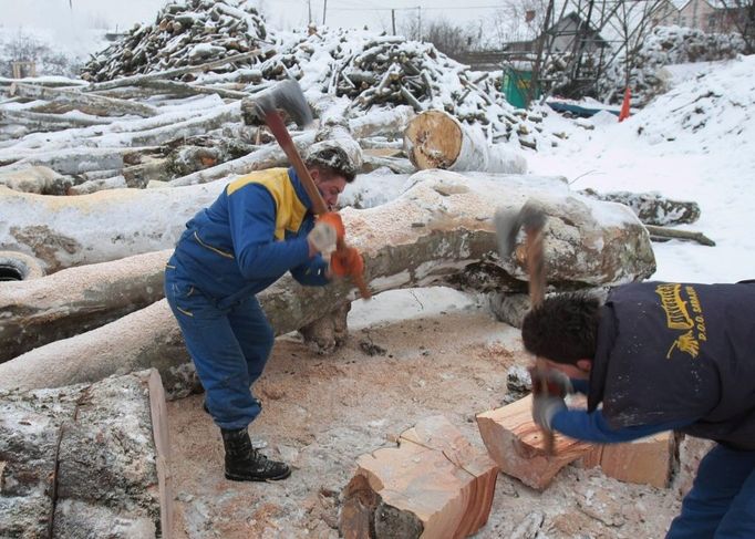 Bosnian workers cuts wood by roadside in Sarajevo, on Thursday, Jan. 8 2009. Small entrepreneurs have started selling wood and coal after deliveries of Russian natural gas to Bosnia were stopped on Tuesday evening. Bosnia imports all of its gas from Russia through Ukraine, Hungary and Serbia. (AP Photo/Amel Emric)