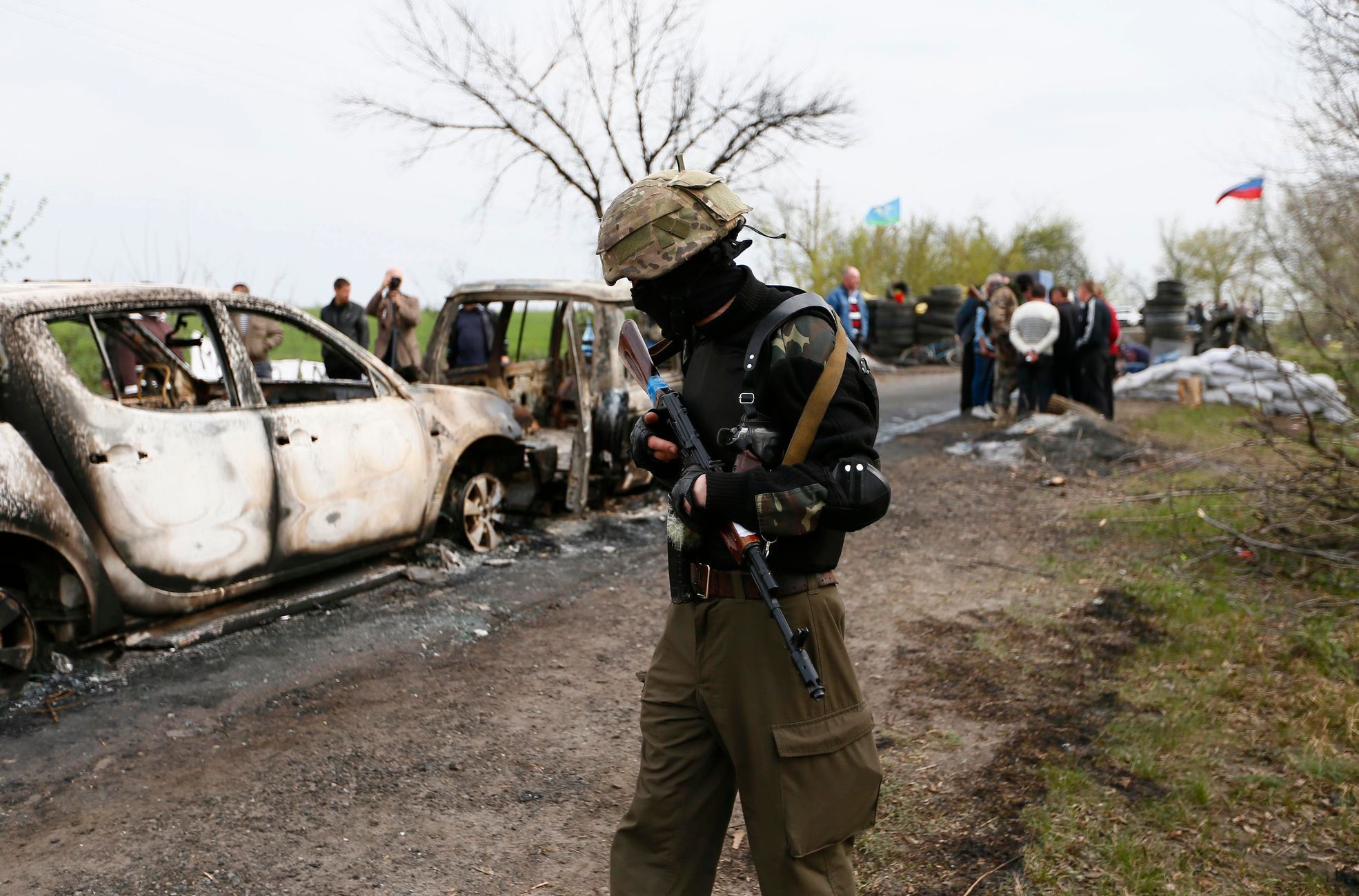 Pro-Russian militant walks near a checkpoint which was the scene of a gunfight overnight near the city of Slaviansk
