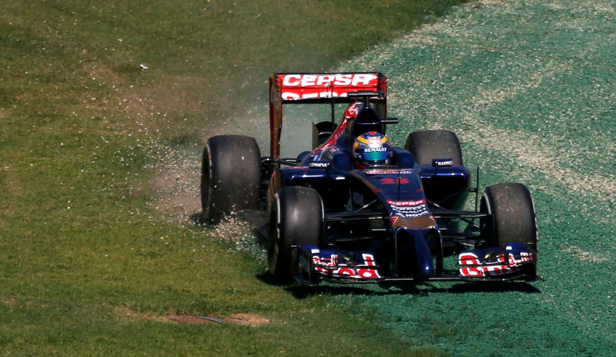 Toro Rosso Formula One driver Vergne of France drives on the grass during the first practice session of the Australian F1 Grand Prix in Melbourne