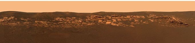 Geologist's Treasure Trove This is a portion of a high-resolution image captured by the Mars Exploration Rover Opportunity's panoramic camera, which shows the puzzling rock outcropping that scientists eagerly wait to investigate. These layered rocks measure only 10 centimeters (4 inches) tall and are thought to be either volcanic ash deposits or sediments carried by water or wind. Photo Credit: NASA/JPL/Cornell