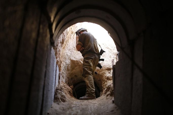 An Israeli soldier looks at a tunnel exposed by the Israeli military, just outside the southern Gaza Strip