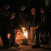 Residents warm themselves by a fire on New Year's Eve in eastern al-Ghouta, near Damascus