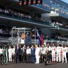 Formula One drivers and officials pray for Marussia Formula One driver Bianchi of France who had an accident in the previous race, before the first Russian Grand Prix in Sochi