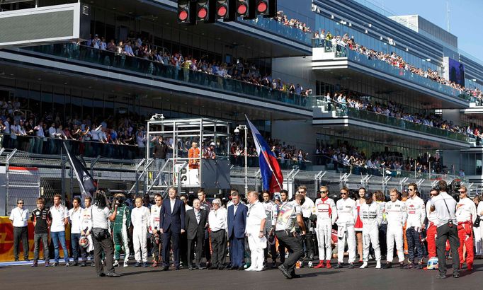 Formula One drivers and officials pray for Marussia Formula One driver Jules Bianchi of France who had an accident in the previous race, before the first Russian Grand Pr