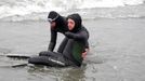 French swimmer Philippe Croizon, four-member amputee (R) is helped to enter the water by his friend, swimmer Arnaud Chassery, on August 11, 2012 on a beach in Wales, Alaska. Croizon will attempt to cross the Bering Strait between Diomede Little Island and Great Diomede island, the last step of his challenge aiming to join symbolically the five continents through passes and straits. Croizon, 43, equipped with leg prothesis, began this project "Nager au-dela des fronti?res (NASF, Swim beyond borders) last May. AFP PHOTO PATRICK FILLEUX, Place: UNITED STATES