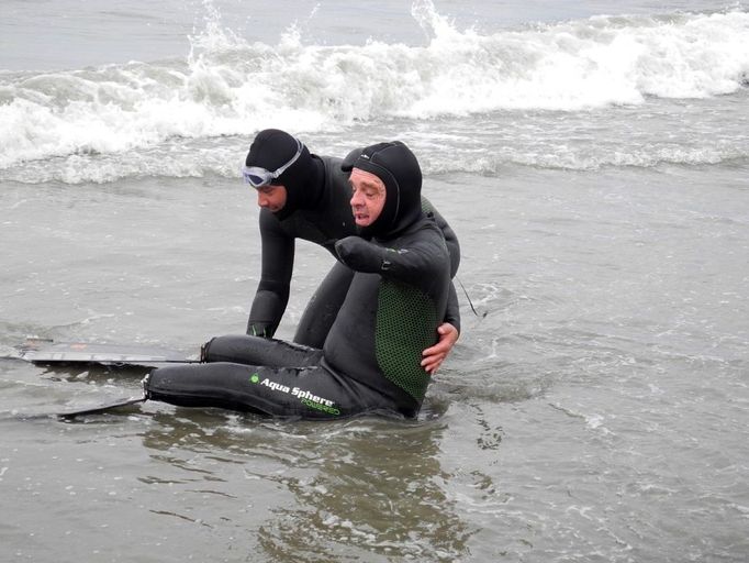 French swimmer Philippe Croizon, four-member amputee (R) is helped to enter the water by his friend, swimmer Arnaud Chassery, on August 11, 2012 on a beach in Wales, Alaska. Croizon will attempt to cross the Bering Strait between Diomede Little Island and Great Diomede island, the last step of his challenge aiming to join symbolically the five continents through passes and straits. Croizon, 43, equipped with leg prothesis, began this project "Nager au-dela des fronti?res (NASF, Swim beyond borders) last May. AFP PHOTO PATRICK FILLEUX, Place: UNITED STATES