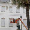 Workers cover the windows of the historic Charleston County Courthouse in Charleston, S.C., in preparation for the advancing Hurricane Florence.