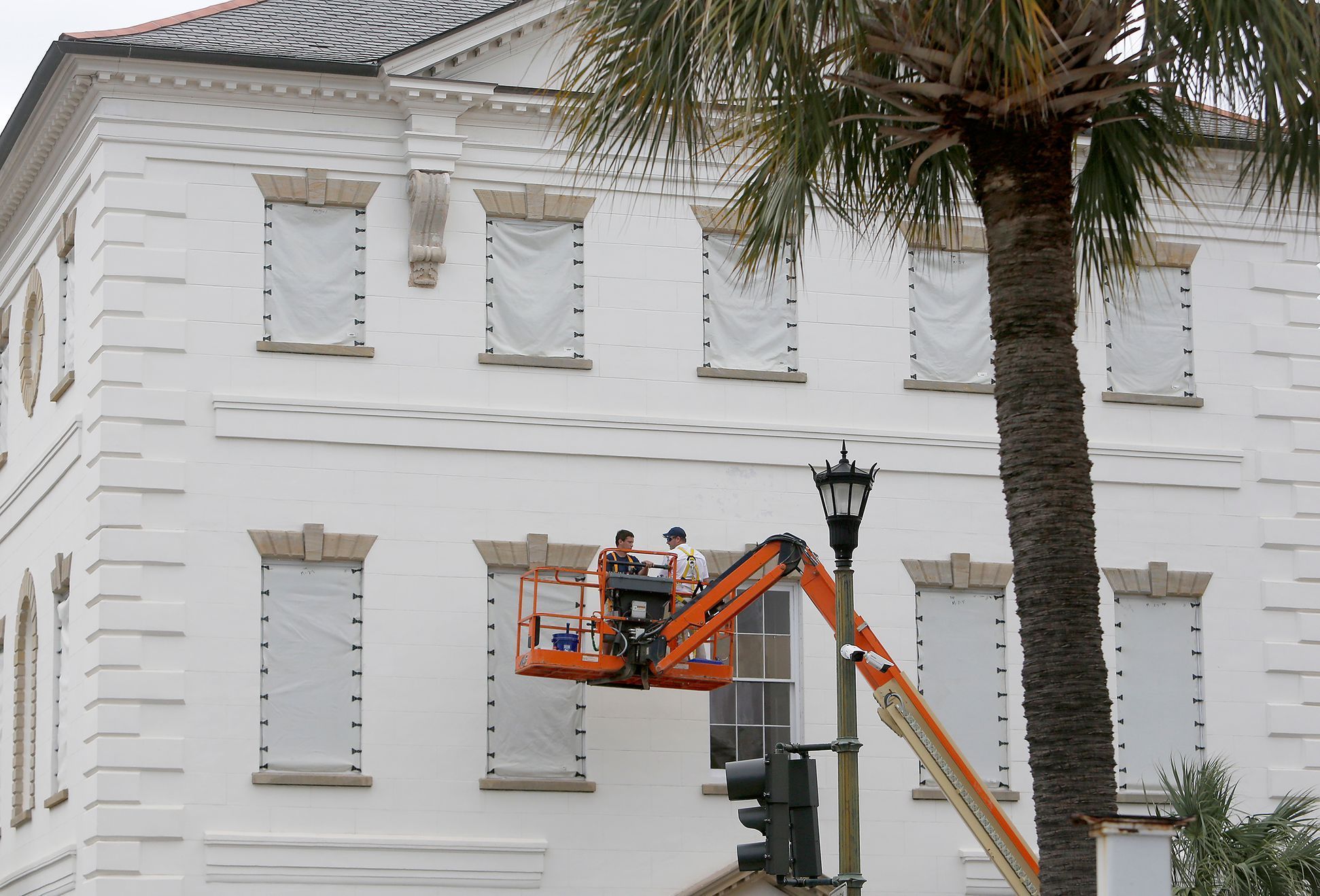 Workers cover the windows of the historic Charleston County Courthouse in Charleston, S.C., in preparation for the advancing Hurricane Florence.