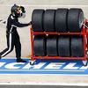 A mechanic transports Michelin tyres during the Le Mans 24-h
