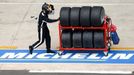 A mechanic transports tyres made by French tyre manufacturer Michelin as he works on the racing circuit during the Le Mans 24-hour sportscar race in central France, June