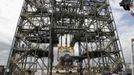 Space center workers stand near the space shuttle Discovery after it was attached to a lifting harness in the Mate Demate facility at Kennedy Space Center in Cape Canaveral