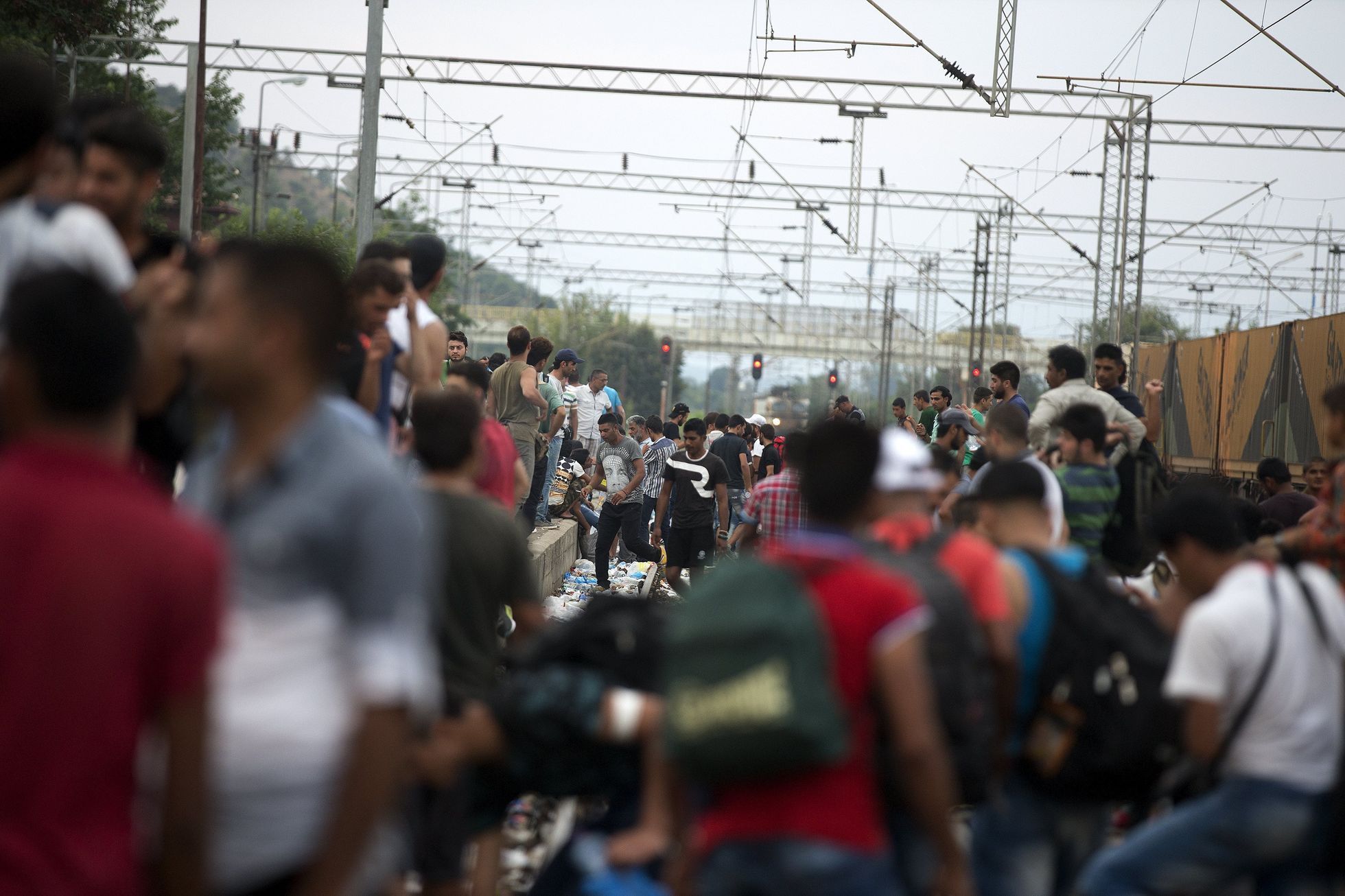 Migrants wait for a train to arrive, at Gevgelija train station in Macedonia