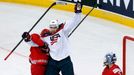 Jimmy Hayes of the U.S. (L) celebrates the goal of team mate Jacob Trouba (unseen) against goalkeeper Andrei Mezin of Belarus (R) during the second period of their men's