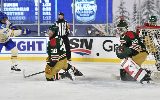 David Perron (57) takes a shot against Minnesota Wild right wing Ryan Hartman (38)