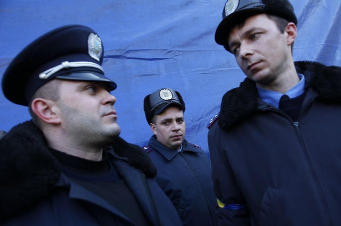 Police officers from Lviv who have arrived to join anti-government protesters appear on a stage in Independence Square in Kiev February 21, 2014.