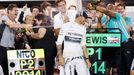 Mercedes Formula One driver Lewis Hamilton of Britain is sprayed with champagne by his team after his win in the Bahrain F1 Grand Prix at the Bahrain International Circui