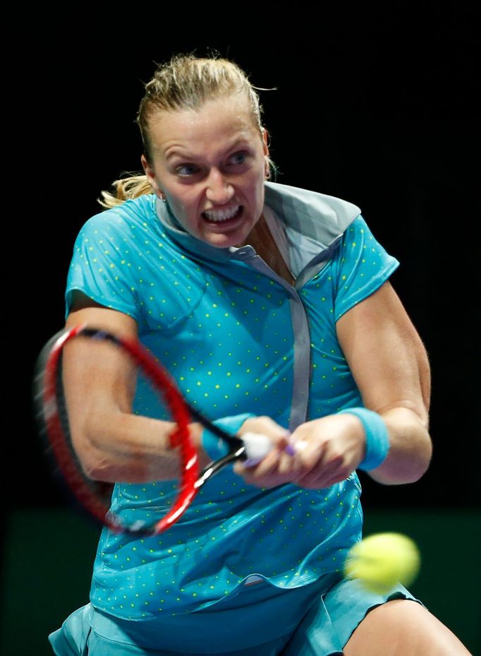 Petra Kvitova of the Czech Republic hits a return to Agnieszka Radwanska of Poland during their WTA Finals singles tennis match at the Singapore Indoor Stadium October 22