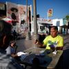 Men play cards in Mariachi Plaza in the Boyle Heights area of Los Angeles