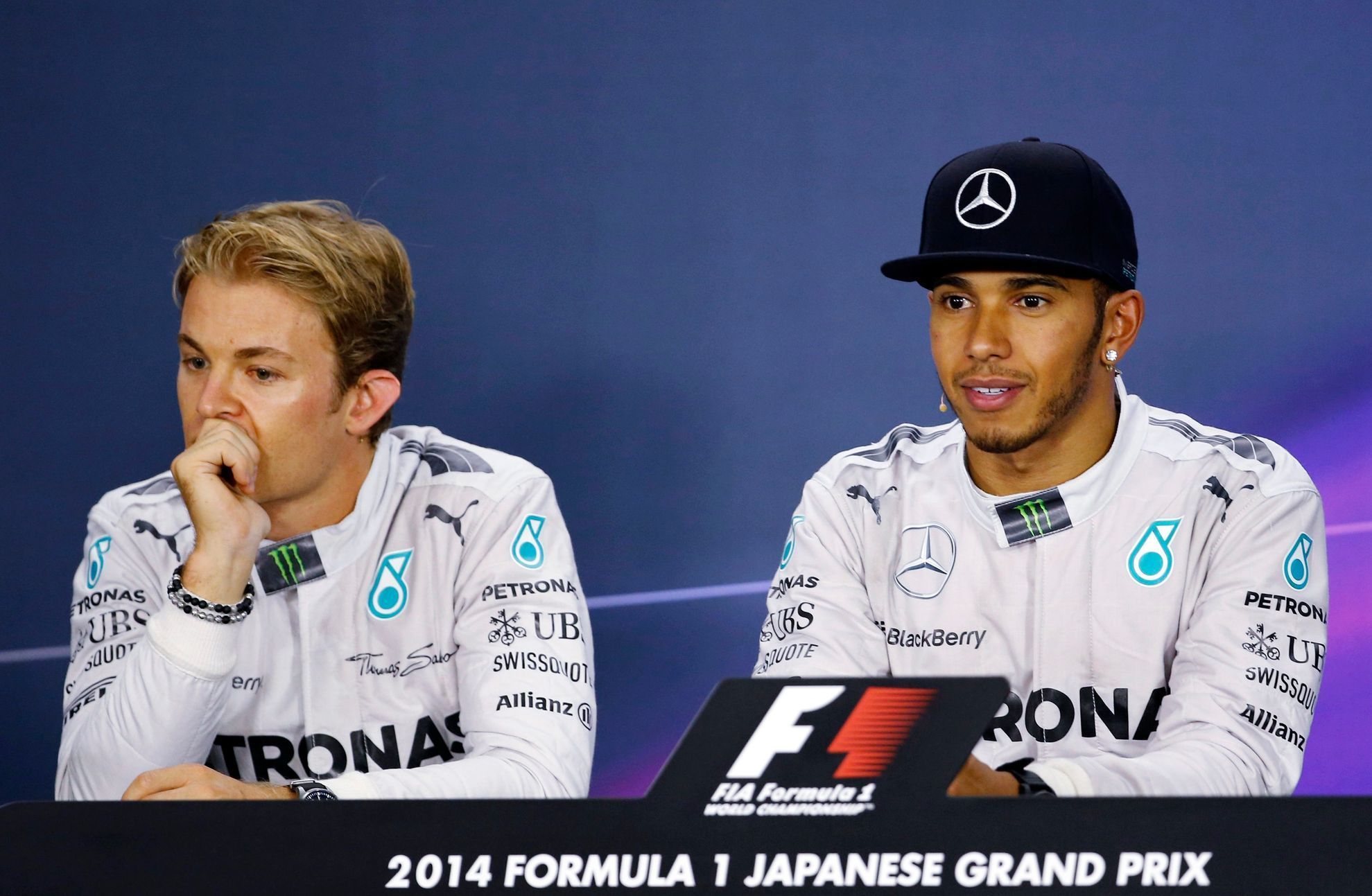 Mercedes Formula One driver Lewis Hamilton of Britain and teammate Nico Rosberg of Germany attend a news conference after the Japanese F1 Grand Prix at the Suzuka Circuit