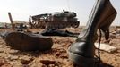 An abandoned pair of military boots are seen on the ground near two armoured vehicles in the recently liberated town of Konna January 26, 2013. REUTERS/Eric Gaillard (MALI - Tags: CIVIL UNREST CONFLICT MILITARY) Published: Led. 26, 2013, 2:23 odp.