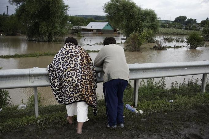 Local residents look at flooded property near the southern Russian town of Krymsk July 7, 2012. At least 99 people were killed in floods and landslides in southern Russia after two months' average rainfall fell in a few hours overnight, police and emergency officials said on Saturday. REUTERS/Vladimir Anosov (RUSSIA - Tags: DISASTER ENVIRONMENT) Published: Čec. 7, 2012, 3:34 odp.