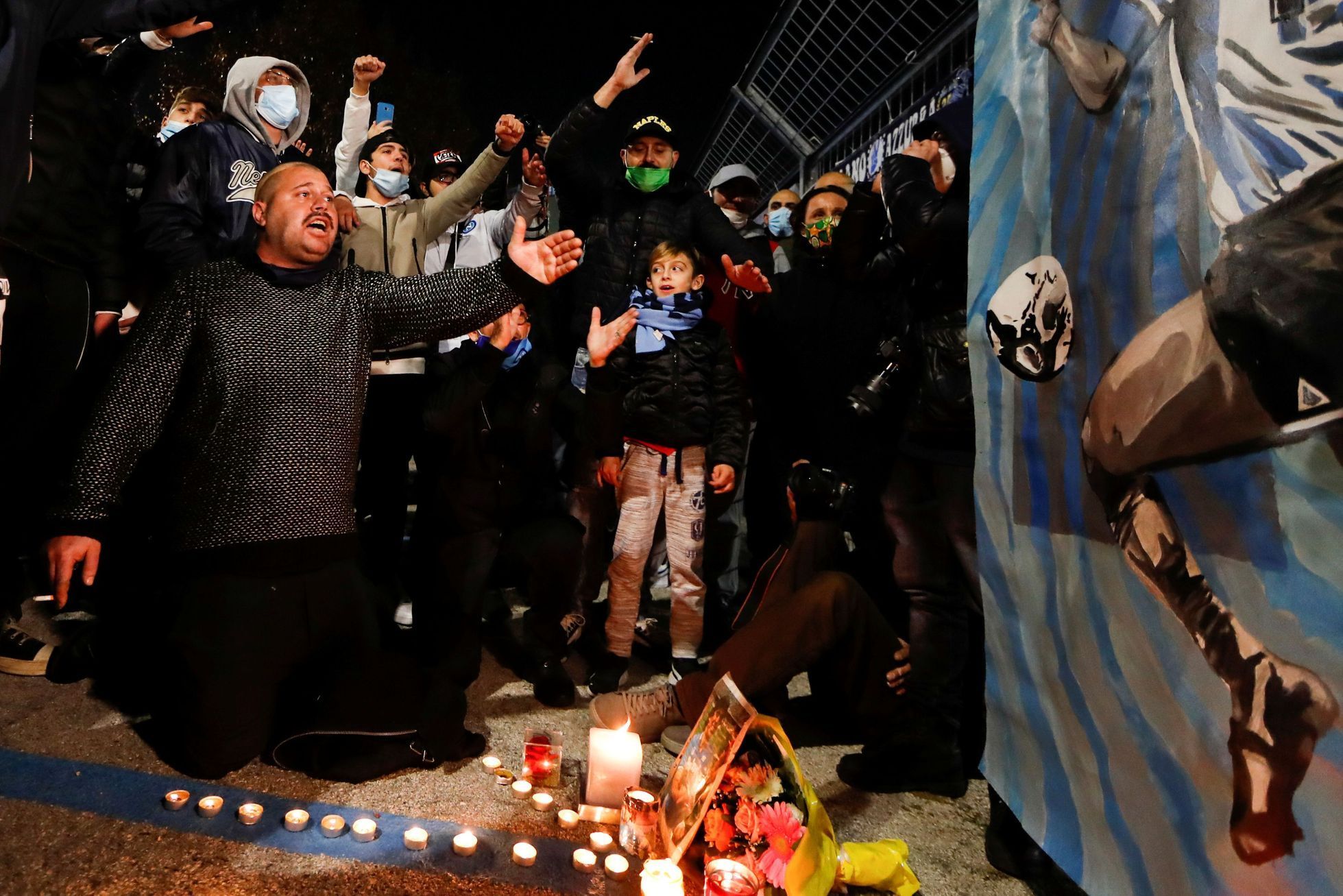 People gather to mourn the death of Argentine soccer legend Diego Maradona, in Naples