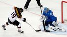 Kazakhstan's goalie Vitali Yeremeyev (R) fails to save a penalty goal in front of Germany's Thomas Oppenheimer (L) during a penalty shoot out during their men's ice hocke