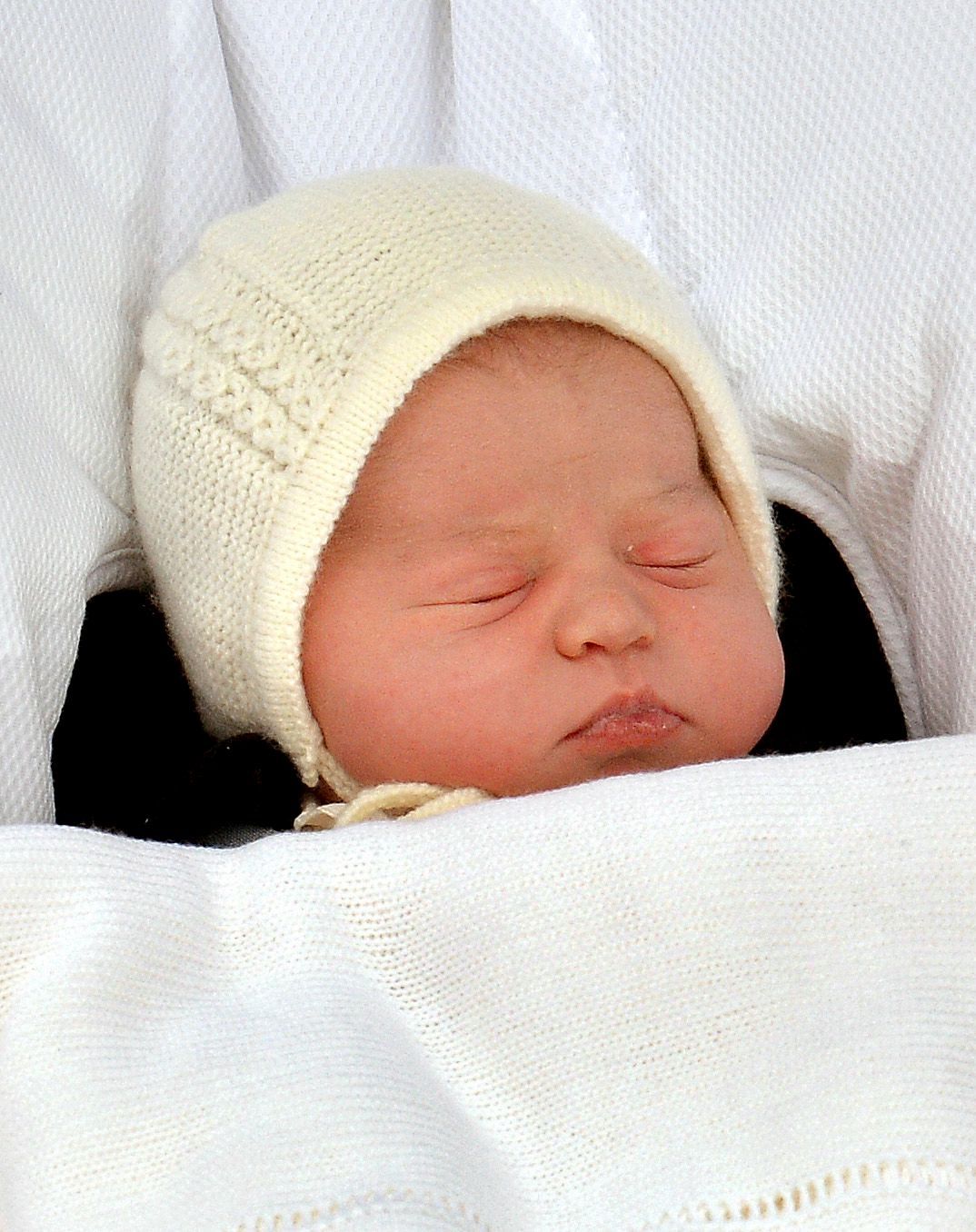 The baby daughter of Britain's Prince William and Catherine, Duchess of Cambridge sleeps as she is carried from the Lindo Wing of St Mary's Hospital in London